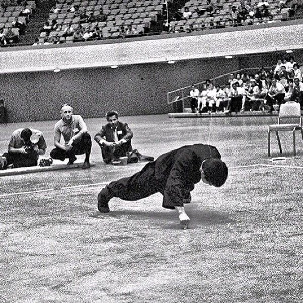 Bruce lee doing pushups with two fingers. 