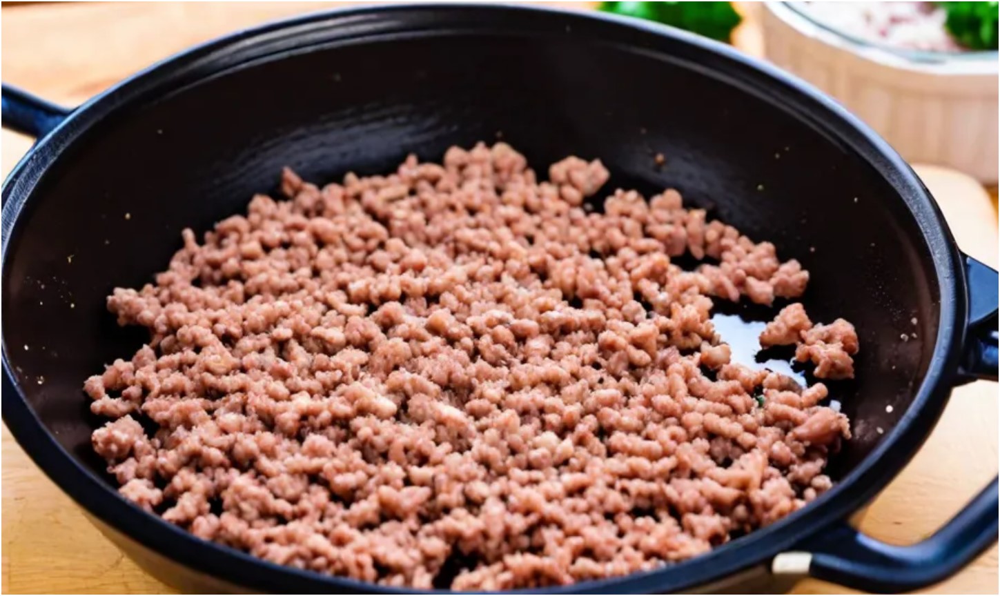 Frying the ground beef in a medium pan over medium heat